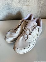 Top view of both New Balance shoes showing laces, toe scuffs and overall condition