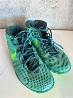 Pair of Nike Kyrie 1 shoes front angle showing mesh upper and laces
