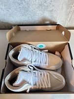 Both left shoes in original box
