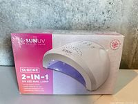 Front of sealed SUNUV SUNONE nail lamp box