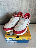 Shoes on box, showing front and top view with tags