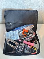 Overview of tool kit showing all contents inside black zippered case