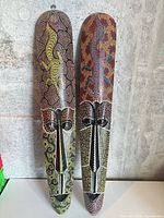 Front view of both painted wooden masks