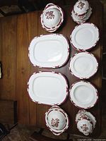 Entire set laid out on table showing platters, plates and covered dishes