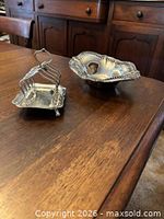 Overall view of silver-plated four-slot toast rack on table