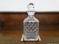 Full front view of square crystal decanter with stopper