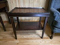 Three-quarter view of table showing tray top, legs, lower shelf