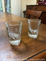 Pair of clear Libbey shot glasses showing heavy fluted bases and tapered bodies