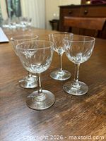 Four Holmegaard Derby crystal wine glasses displayed on wooden table