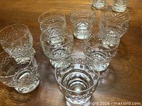 Top view of eight Waterford Lismore footed juice glasses showing matching cut pattern