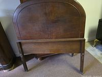 Arched panel headboard with its footboard in front