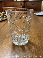 Cylindrical cut crystal ice bucket showing pinwheel and wedge cuts, thick starburst base