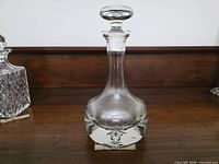 Full view of clear glass Krosno ship’s decanter with stopper in place
