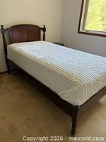 Side view of assembled twin bed showing full frame, mattress, headboard and corner posts