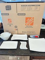 Overview of seven visible dinnerware pieces on countertop