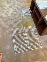Wire shelf risers laid out on carpet