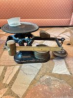 Full view of Fairbanks balance scale with weights on and around base