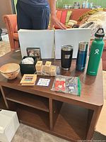 Group shot showing all items including tumblers, bowl, box, coasters, keyrings and stamp blocks