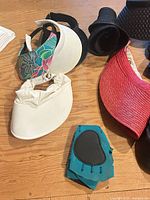 Group of visors, roll-up hat and water shoe piece