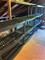 Full view of all four black plastic shelving units lined up