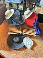 Group shot showing all items: two folding chairs, backpack, tote, hats