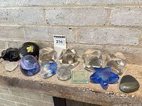 Full grouping of eleven paperweights on mantel