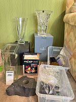 Overall lot showing boxed Waterford and Chesswood vases, AquaBlum box, plastic bin with marbles and plastic frogs, slate flower frog