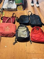 Group shot of five bags on floor