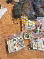 Overall lot with mosquito jacket, first aid bags, repellent sprays