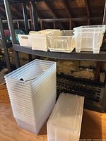 Stack of clear bins, white bins, clear drawers on shelf