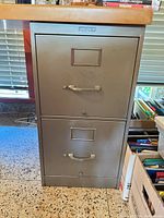 Front view showing two drawers, handles, label frames, Office Specialty badge