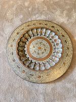 Front view showing full decorative brass plate with inlay and engraved motifs
