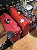 Two red hardside suitcases with rack stacked