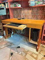 Front view of desk under shelving showing keyboard tray and CPU shelf