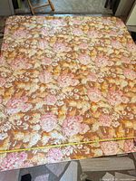Full view of floral fabric laid out, measuring tape visible