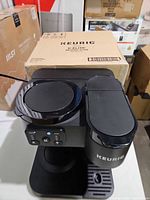 Full view of Keurig K-Duo coffee maker with box behind