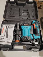 Demolition hammer in open carry case with accessories visible