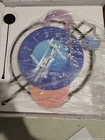 Clock in protective packaging showing overall components