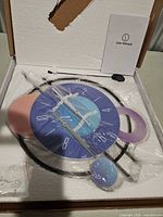 Clock, user manual and hardware inside foam packaging