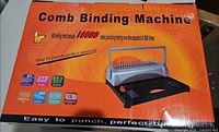 Retail box top showing comb binding machine image and capacity claims