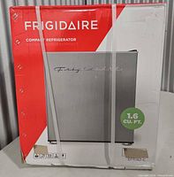 Front of sealed Frigidaire compact refrigerator box showing model image and capacity