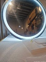 Front view of illuminated round LED mirror