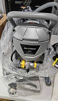 Front view of Maxpray M1 sprayer with accessories in packaging