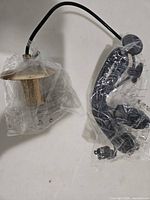 Brass shade with cord and black mounting arm in original plastic bags