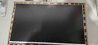 Front of 25-inch monitor panel in packing tray