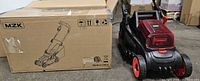 MZK cordless lawn mower beside original box