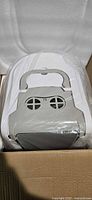 Top view of litter box in packaging showing carry handle and vented lid