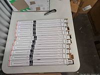 Ten boxed Sylvania Dulux L 40W bulbs laid out