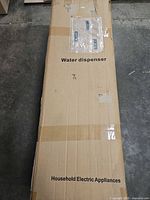 Full view of boxed water dispenser labeled Water dispenser Household Electric Appliances