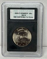 Obverse of 2000-P Kennedy half dollar in INB slab showing label and certification